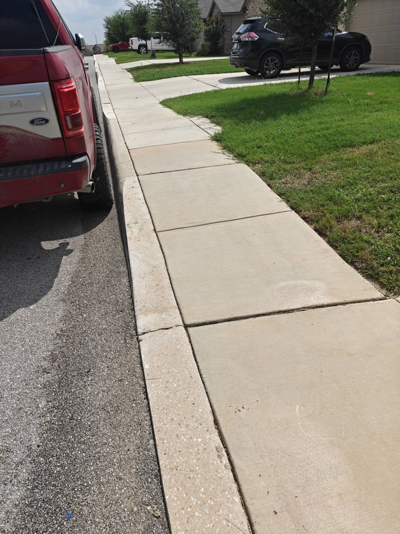 Clean curbside concrete and exterior approach after Titan Wash service
