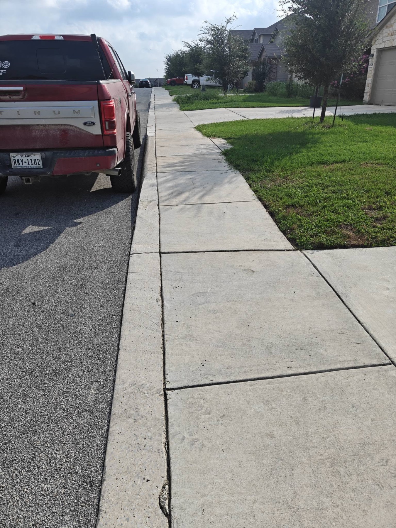Curbside sidewalk before Titan Wash concrete cleaning