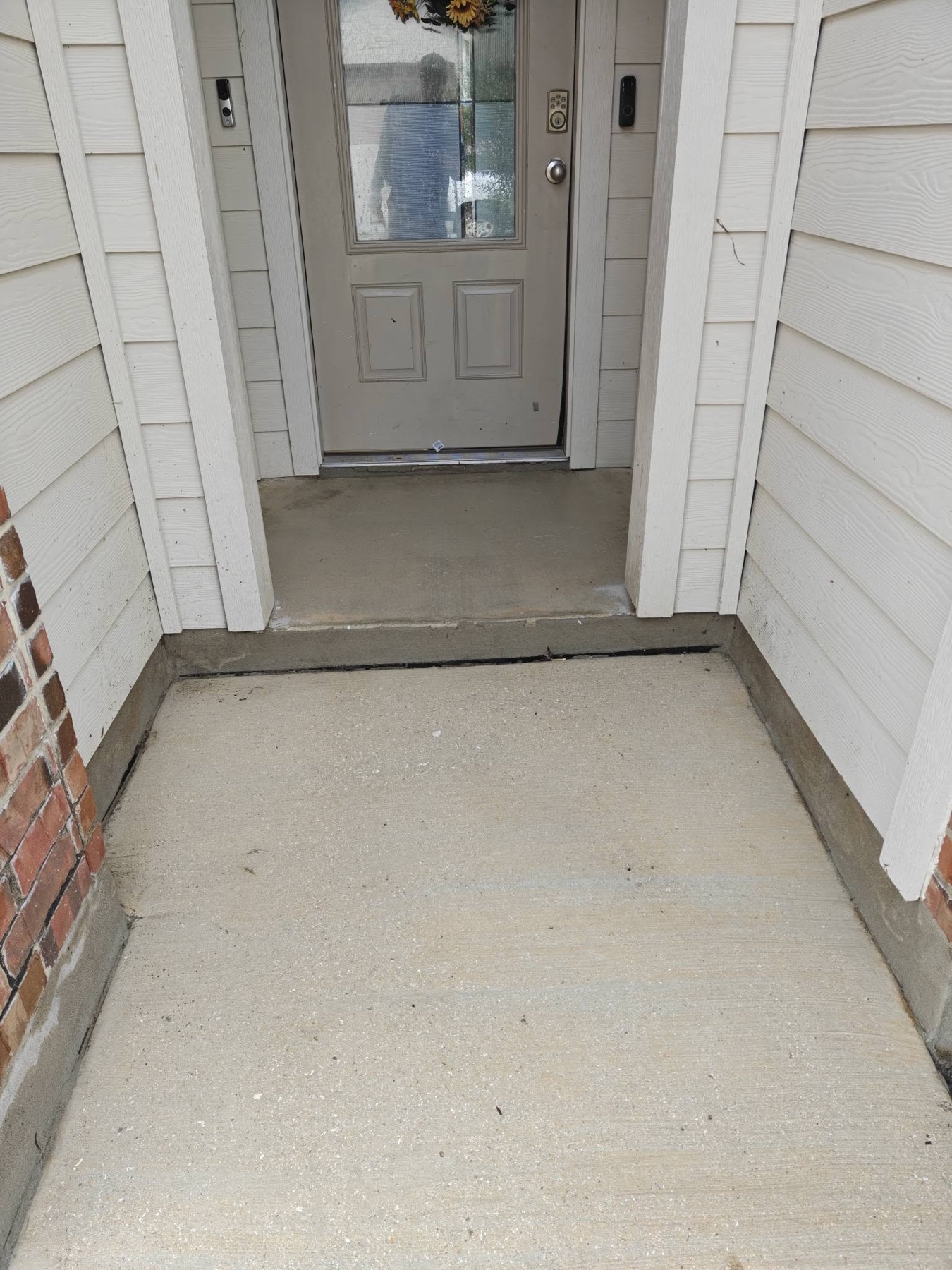 Close-up of front porch concrete after Titan Wash cleaning
