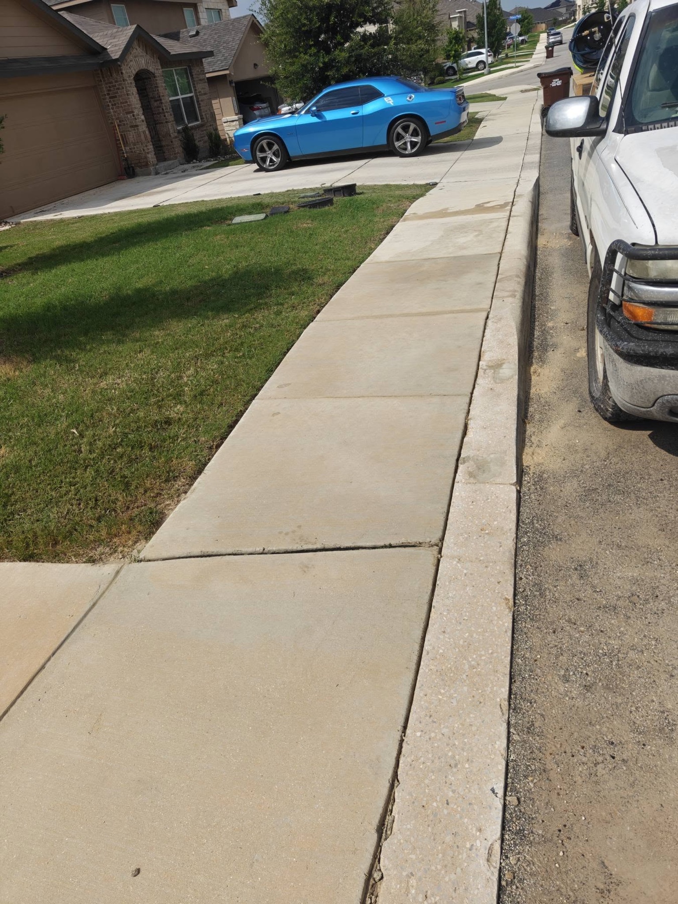 Clean residential sidewalk after Titan Wash pressure washing
